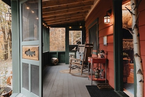 Screened in porch with rocking chairs