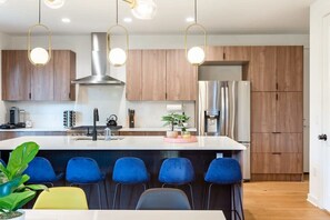 Modern Kitchen With A Large Island And High Chairs