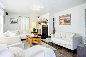 Relax by the fireplace in a warm, inviting lounge space.