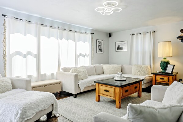 Bright, cozy living room with plush seating and natural light.