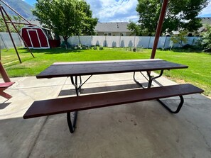 Large picnic table on patio.