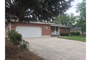 Front view with roses lining the driveway.