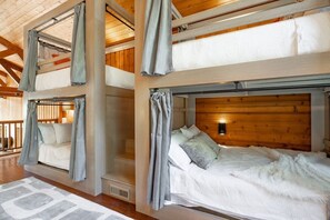 Queen Size custom made bunk beds with curtains and private lighting.