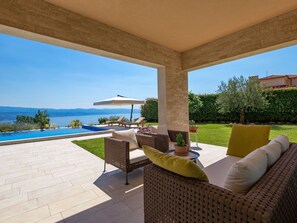 Sky, Plant, Furniture, Property, Water, Building, Shade, Outdoor Furniture, Chair, Tree