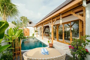 Side view of the authentic pool and outside living area 