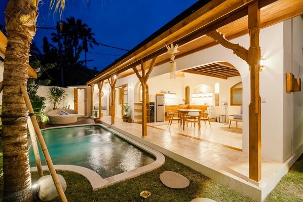 View of the outside space and the front of the villa at night