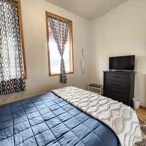 Bedroom #1 with vaulted ceilings and sweeping ocean views.