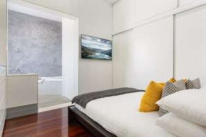 Main bedroom with queen bed and enormous open ensuite with large spa bath