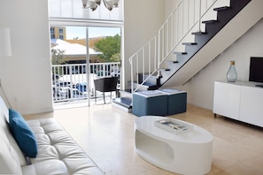 Nicely appointed living room with seating area and flat screen TV