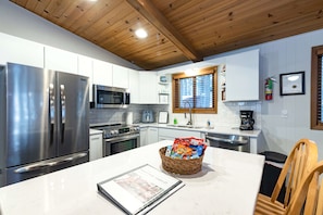 Counter space, kitchen area, complimentary gift basket, and check in guide.