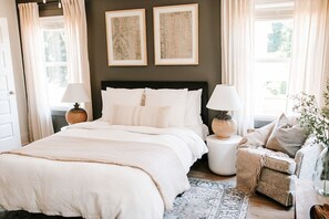 Experience the ultimate in luxury sleep. The second-level primary bedroom boasts an en-suite bathroom, a queen-sized Purple mattress, and Organic Supima Cotton linens for the perfect restful night.