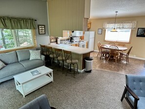 Open concept living room leads to kitchen and dining area.