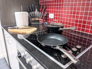 Kitchen with a range of utensils and pots