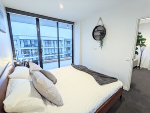 Bedroom with king size bed, and block out blinds