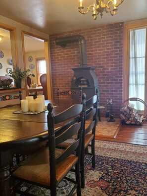Dinning room that comfortably seats 10 with a wood burning stove