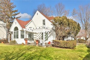 South facing wrap around garden with white picket fence 