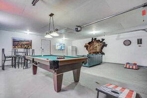 Kick back in front of the large 55" Smart TV, get competitive in a game of pool, or hang out and enjoy a game of corn hole!