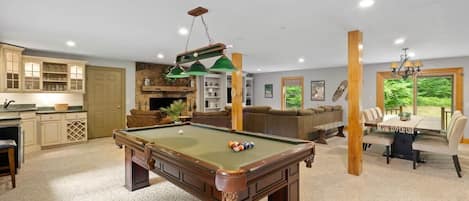 Spacious first floor with pool table, foosball, couches, wet bar, dining room and kitchen!