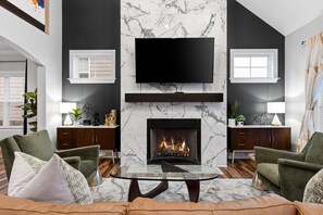 Check out your latest shows  on the big screen TV and cozy up to the fire