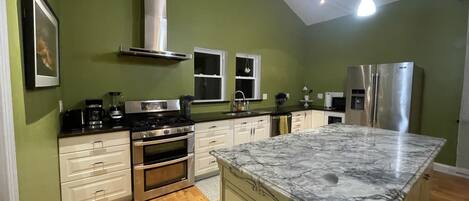 Kitchen with a gorgeous Marble Island and stainless steel appliances