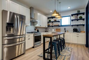 Beautiful stainless steel appliances shine in this open kitchen area.