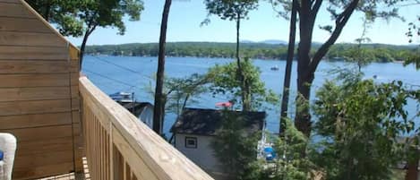 Relax in the Lakes Region! Enjoy boats going by your deck on Lake Winnisquam!