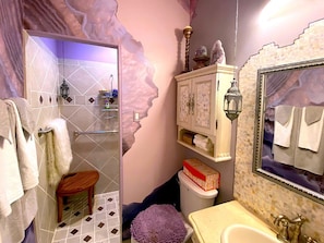 Geode themed bathroom, walk-in shower,  towels and toiletries