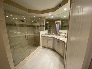 Primary bathroom w/ large step in shower and double vanity. Walk in closet also.
