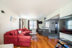 Living Room: Bright space with plush seating and open kitchen, perfect for socializing and relaxing!