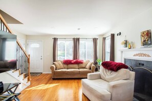 Living Room: Sunlit space with plush seating, perfect for unwinding after a day of exploring!
