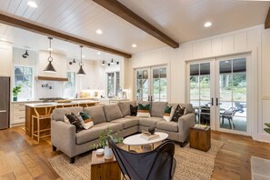 Living Room with Kitchen Behind and Outdoor Living Space Patio