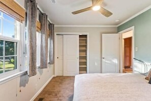 Relax in Bedroom 1, featuring a comfortable queen bed with plush bedding, perfect for a restful night after exploring Reno.