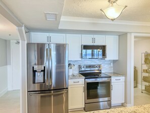 Fully stocked kitchen with new appliances.