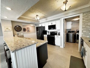 Fully stocked kitchen with new appliances.