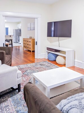 Living room with comfortable seating and a Smart TV.