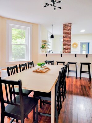 arge dining area with seating for eight at the kitchen table and four at the bar.