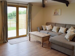 Cosy living area with French doors to garden and patio | Horseshoe Cottage - Old Chalksole Cottages, Alkham, near Dover