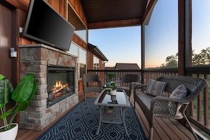 Enjoy movie night on the screened-in porch with a fireplace. It's the perfect place to relax after a day of fun!