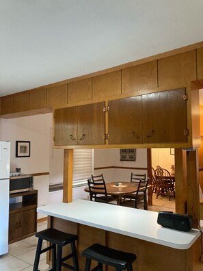 View of kitchen dining area with a peek of formal dining area. 