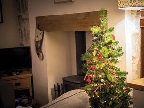 Festive touches add a seasonal sparkle to the living room | Under Moor Cottage, Manod, near Blaenau Ffestiniog