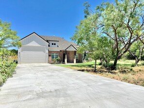 Front of home with large driveway for boat trailers.