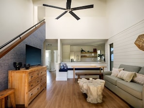 Relax in our spacious living room with a queen sofa sleeper, high ceilings, and modern comforts.