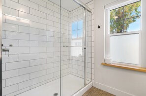 Custom tiled walk-in shower with glass doors