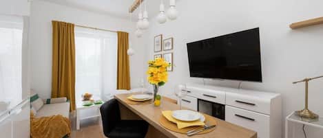 A modern sofa with mustard yellow cushions adds a pop of color to the bright living space.