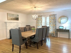 Main House: Large dining room table seats 8-10. This open-concept kitchen/dining area is an excellent space; entertain around the large kitchen island with additional bar seating and use the folding table and extra chairs to seat the whole group!