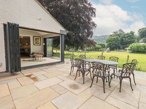 Garden room with double set of bi-folding doors opening onto patio 