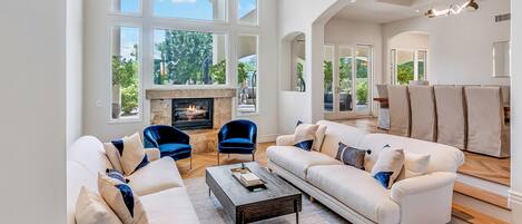 Your formal living room with fireplace and stunning garden views.