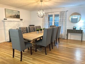 Large dining room table seats 8-10. This open-concept kitchen/dining area is an excellent space; entertain around the large kitchen island with additional bar seating and use the folding table and extra chairs to seat the whole group!