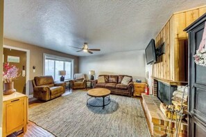 Imagine relaxing in this spacious living area, complete with plush seating and a flat-screen TV. The natural light pouring in from the windows creates a bright, welcoming space where you can truly unwind and enjoy your stay. (Main living area and private entrance)