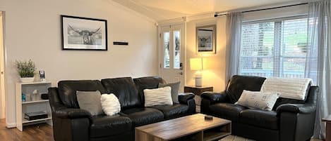 Living/dining area in the adjacent Guest House- This additional area features 1 King bedroom with en suite full bath with soaking tub and shower, and 2 guest bedrooms with queen beds and a shared hallway full bath.